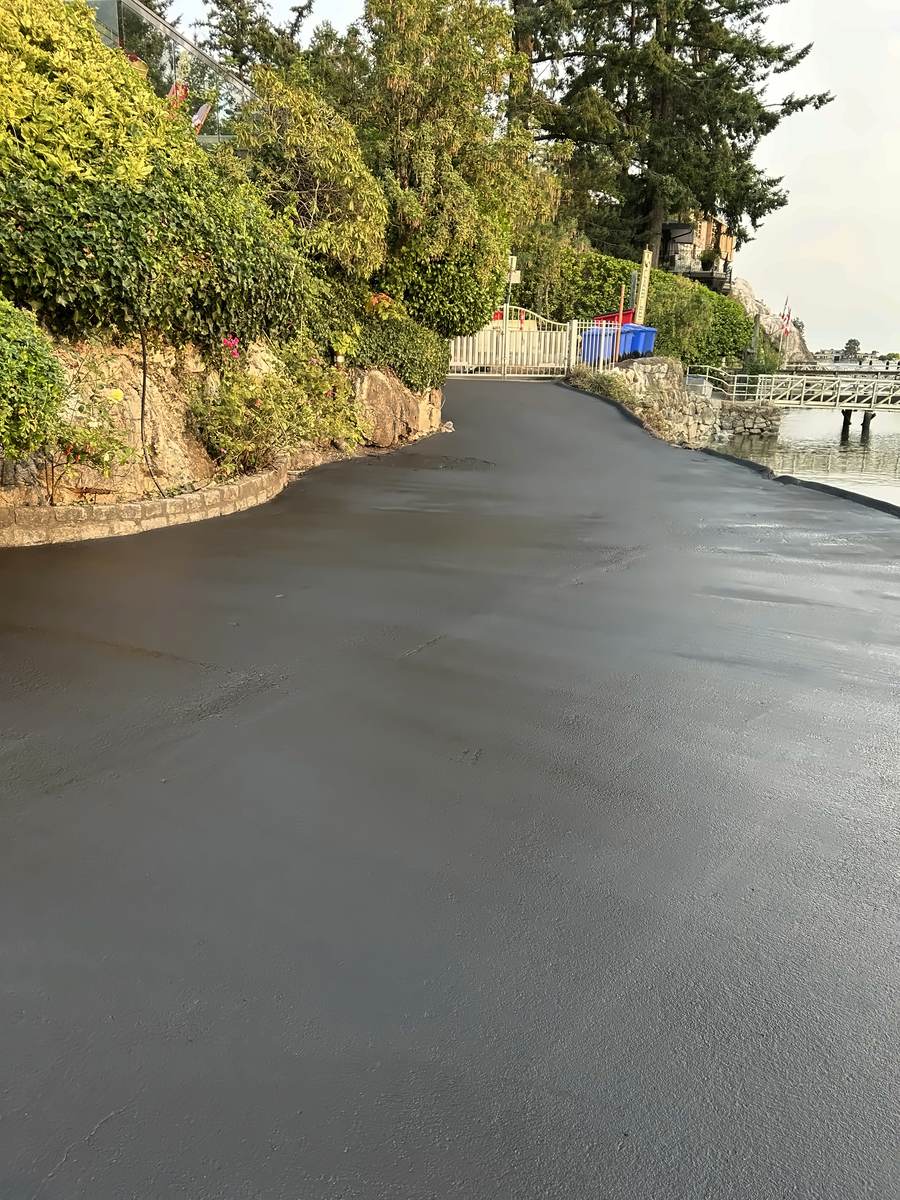 Finished sealed driveway along the seawall leading to the gate
